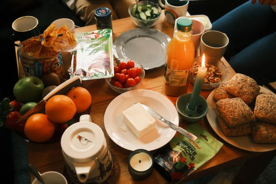Cozy home breakfast spread with fresh fruit, bread, and juice on a table